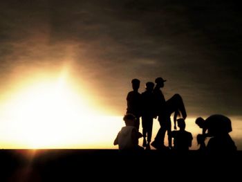 Silhouette couple against clear sky during sunset