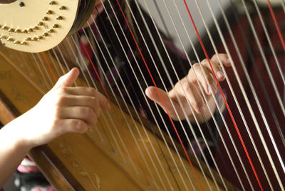 Harp player playing beautiful  emotional classical piece of music in high end luxury wedding event