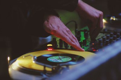 Close-up of club dj playing music on turntable