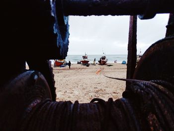 Close-up of man on beach against sky