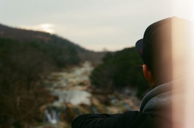 Close-up portrait of man against sky