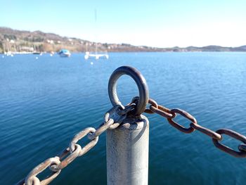 Close-up of chain against sea