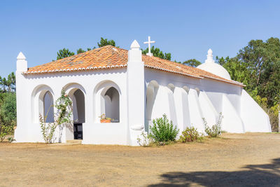 White walls and red tile roof of an old catholic church in portugal