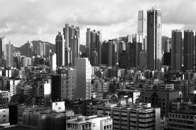 Aerial view of buildings in city against sky