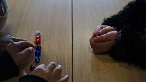 Rear view of people playing on table