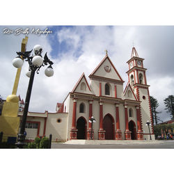 Low angle view of church against cloudy sky