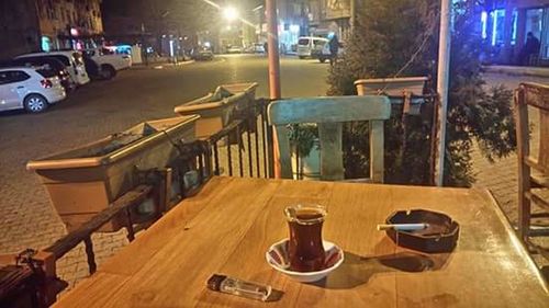 Chairs and tables at sidewalk cafe at night