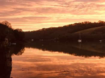 Scenic view of lake against orange sky