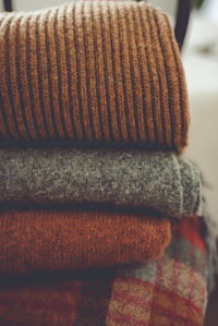 Close-up of sweaters stacked at home