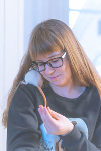 Close-up of smiling girl with rat