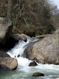 Scenic view of river flowing through rocks