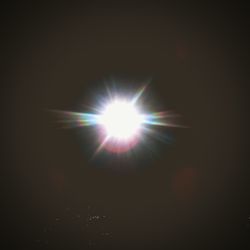 Sun shining over dark background