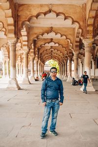 Portrait of man standing at historical building