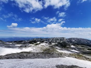 Scenic view of mountains against blue sky