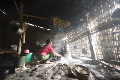 Rear view of man working in abandoned building