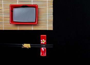 Directly above shot of telephone booth against black background