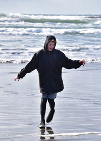 Full length portrait of man standing on beach