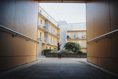 Girl doing cartwheel in neighborhood courtyard