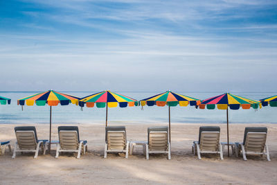 Colorful umbrella at the beach with blue sky.