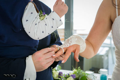 Midsection of couple holding hands