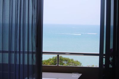 Close-up of sea against sky seen through window
