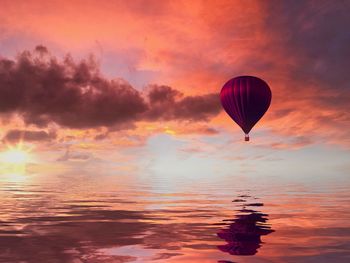 Hot air balloon flying over cloudy sky