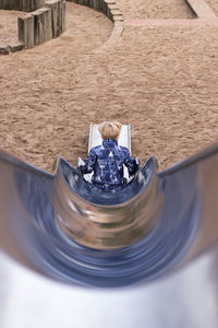 Rear view of boy on slide