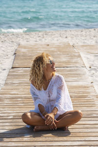 Young woman sitting at beach