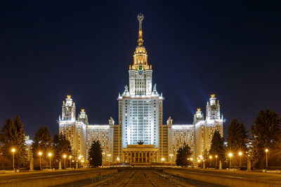 Illuminated historic buildings against sky at night