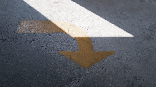 High angle view of arrow sign on road