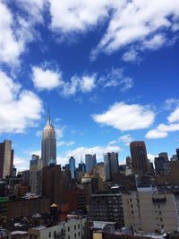 View of cityscape against cloudy sky