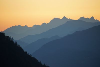 Scenic view of silhouette mountains against sky during sunset