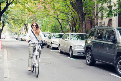 Woman riding bicycle on road