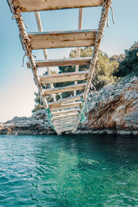 Bridge over sea against clear sky
