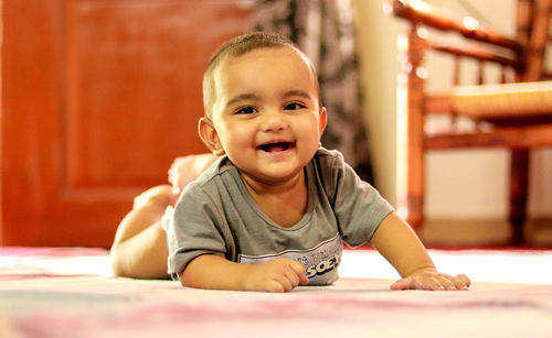 Portrait of cute boy smiling on table