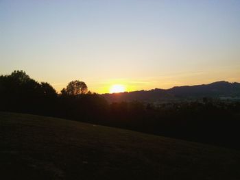 Scenic view of landscape against sky at sunset