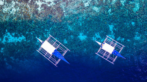 High angle view of wind turbines in sea