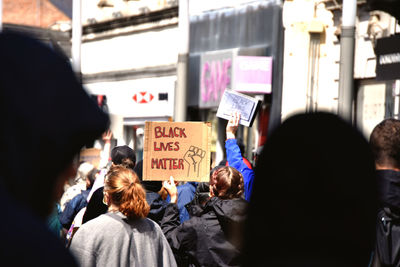 Rear view of people walking on street