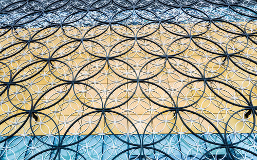 Low angle view of window on tiled floor against building