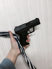 Close-up of woman holding handgun