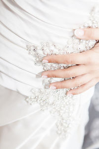 Midsection of bride wearing white wedding dress