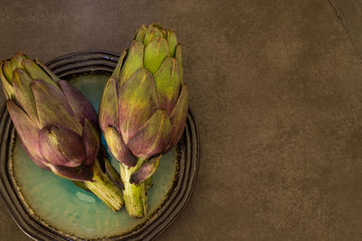 High angle view of artichokes in plate on table