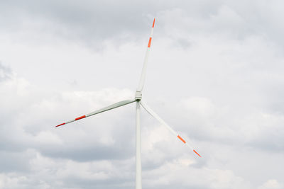 Low angle view of windmill against sky