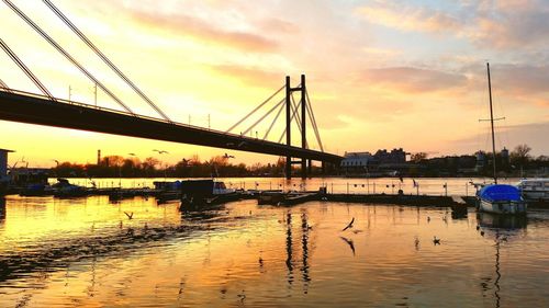 Bridge over river at sunset