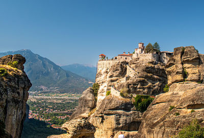 Panoramic view of trees and mountains against clear blue sky