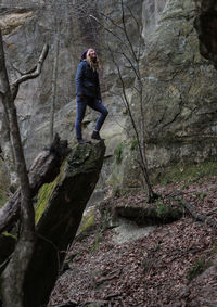 Woman standing on rock against mountain