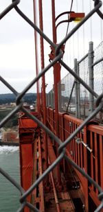 Close-up of chainlink fence against built structure