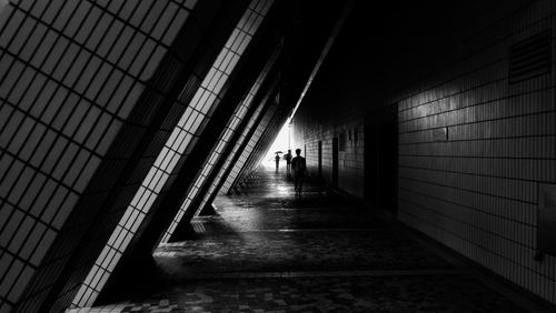 Rear view of woman walking in corridor