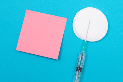 High angle view of pencil on table against blue background