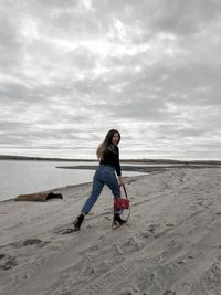 Full length of man on beach against sky